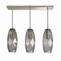 Three pendant light fixture with geometric glass shades and metal accents