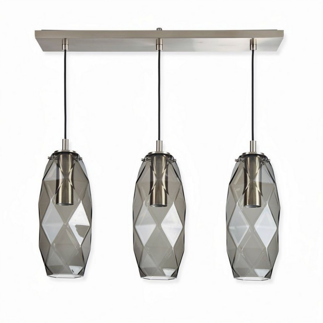 Three pendant light fixture with geometric glass shades and metal accents